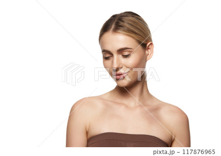 Young woman with perfect, clear skin, reflecting success of skin care and cosmetic treatments, isolated on white studio background Young woman with perfect, clear skin, reflecting success of skin care and cosmetic treatments, isolated on white studio background 117876965