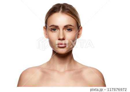 Portrait of beautiful young woman with clear, smooth, spotless complexion, nude makeup isolated on white studio background 117876972