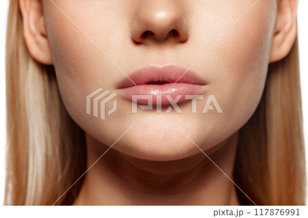 Plump, beautiful female lips. Close-up cropped image of female lower face part with well-kept skin and hydrated lips. Concept of lip care, Plump, beautiful female lips. Close-up cropped image of female lower face part with well-kept skin and hydrated lips. Concept of lip care, 117876991