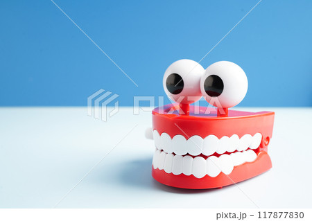 Funny red teeth with eye toy denture model for dental health care. 117877830