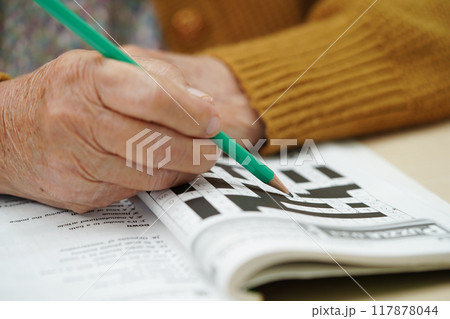 Bangkok, Thailand - May 15, 2022 elderly woman playing sudoku puzzle game. 117878044