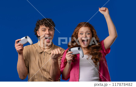 Couple Playing Video Exciting Game On Tv With Joystick gamepad controller,Studio 117878482
