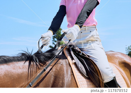 馬に乗って乗馬の練習をする女性 117878552