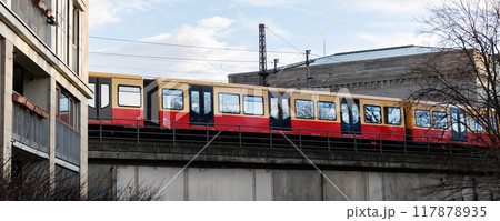 Scenic evening view S-bahn subway train bridge in Berlin Mitte central district near residential apartment house building facade. Urban european transport commute cityscape Germany scene background Scenic evening view S-bahn subway train bridge in Berlin Mitte central district near residential apartment house building facade. Urban european transport commute cityscape Germany scene background 117878935