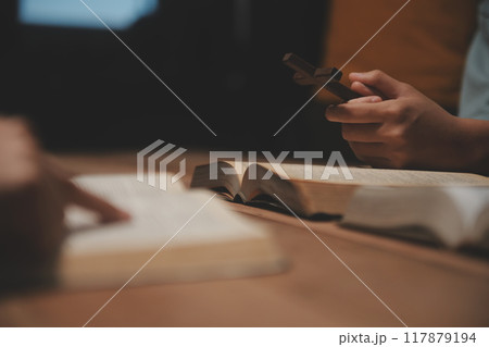 Christian group are praying to god with the bible and sharing the gospel. Concept of faith for god. 117879194