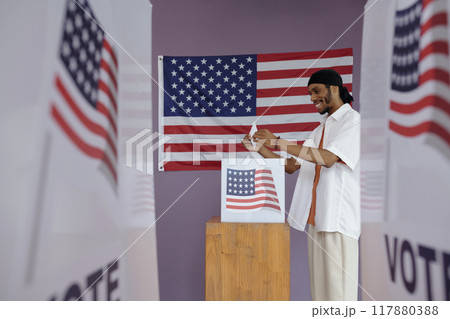 Man Throwing Envelope In Box To Vote Man Throwing Envelope In Box To Vote 117880388