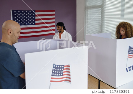 People Standing In Booth And Voting 117880391