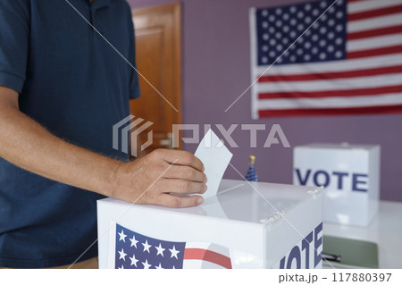 Man Putting Bulletin In Box Man Putting Bulletin In Box 117880397
