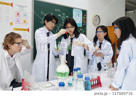 Students Engaging in Chemistry Experiment in Laboratory Students Engaging in Chemistry Experiment in Laboratory 117880716