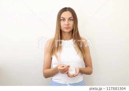 Frustrated young woman with hair loss problem holds hair brush and shows on bunch of fallen hair after combing. Alopecia, endocrine disorder, hormonal imbalance, postpartum period, stress concept Frustrated young woman with hair loss problem holds hair brush and shows on bunch of fallen hair after combing. Alopecia, endocrine disorder, hormonal imbalance, postpartum period, stress concept 117881304