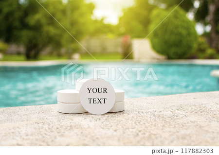 Chlorine tablets for swimming pool disinfection with space for text. Chlorine tablets for swimming pool cleaning with space for text, chlorine tablets on the edge of a swimming pool Chlorine tablets for swimming pool disinfection with space for text. Chlorine tablets for swimming pool cleaning with space for text, chlorine tablets on the edge of a swimming pool 117882303