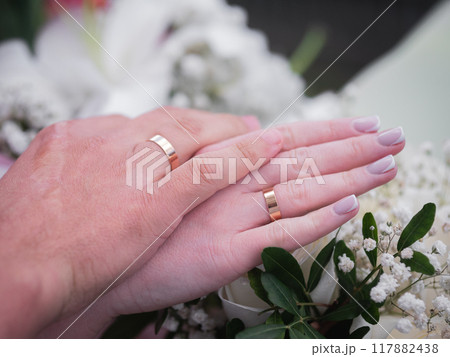 newlyweds hands close with wedding rings newlyweds hands close with wedding rings 117882438