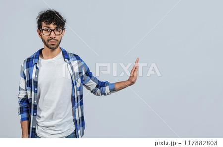Displeased young man rejecting with rejection gesture, throw palms isolated. Displeased person with rejection gesture isolated, pulls palms in rejection, frowns in disgust Displeased young man rejecting with rejection gesture, throw palms isolated. Displeased person with rejection gesture isolated, pulls palms in rejection, frowns in disgust 117882808