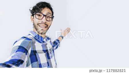 Man pointing back and presenting a product, Young man welcoming you isolated, person welcoming you with one hand. Friendly man inviting you to come Man pointing back and presenting a product, Young man welcoming you isolated, person welcoming you with one hand. Friendly man inviting you to come 117882821