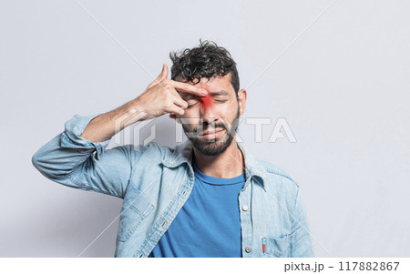 Young man with pain touching nose. A person with nasal bridge pain, Man with nasal bridge headache. Sinus pain concept Young man with pain touching nose. A person with nasal bridge pain, Man with nasal bridge headache. Sinus pain concept 117882867