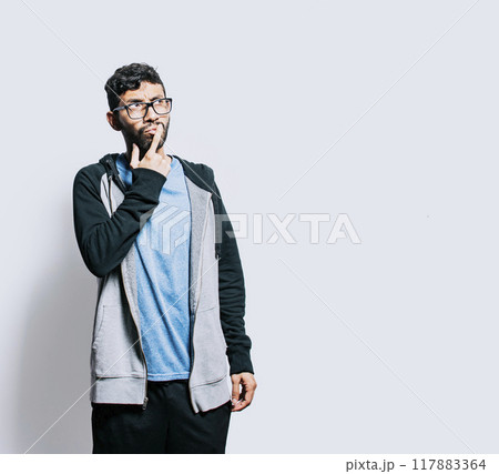 Person wondering with hand on chin isolated, Thoughtful person rubbing his chin, Concept of wondering man with doubt face 117883364