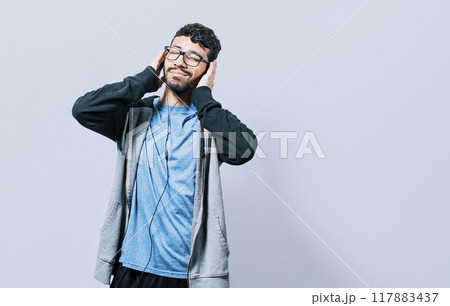 People enjoying music with headphones isolated, cheerful guy listening to music with his cell phone isolated, Person listening to music with his cell phone with headphones isolated 117883437