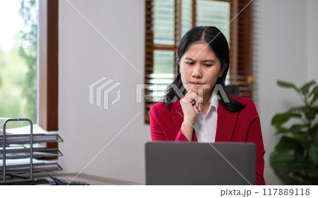 Young businesswoman has problems with her work in the office Feeling stressed and unhappy, showing a serious expression Young businesswoman has problems with her work in the office Feeling stressed and unhappy, showing a serious expression 117889118