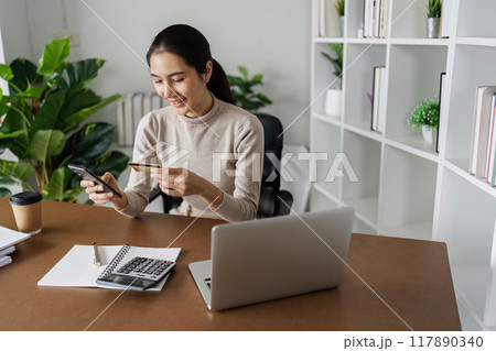Woman on desk with smartphone, credit card and ecommerce payment for online shopping at home 117890340