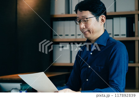 相続税申告書の記入をする男性 117892839