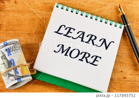 LEARN MORE text on a blank sheet of notebook against a papyrus background LEARN MORE text on a blank sheet of notebook against a papyrus background 117893752