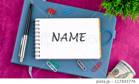 NAME word written in a notebook on a blank page 117893776