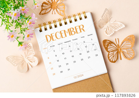 December 2024 desk calendar and paper butterfly with flower. December 2024 desk calendar and paper butterfly with flower. 117893826
