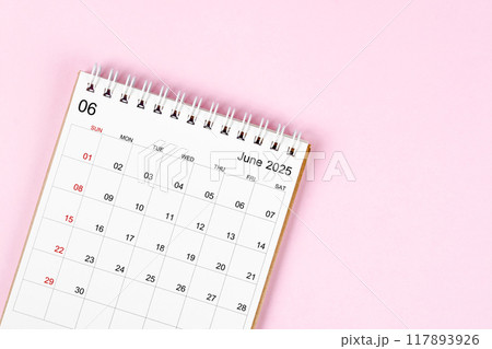 June 2025 desk calendar on pink background, Position with empty space. 117893926