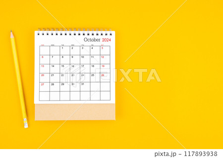 October 2024 desk calendar and wooden pencil on yellow color background. 117893938