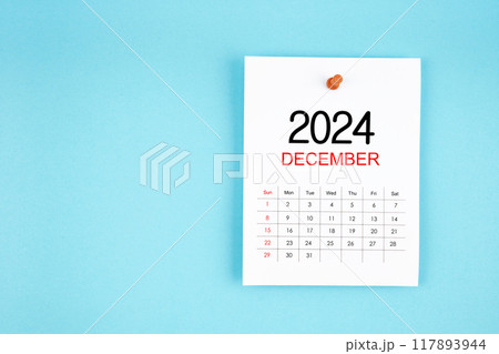 December 2024 calendar page with push pin on blue background. December 2024 calendar page with push pin on blue background. 117893944