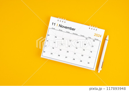 November 2024, Monthly desk calendar for 2024 year and pen on yellow background. 117893948