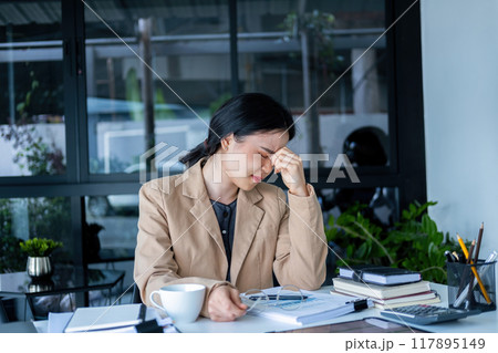 Businesswoman is thinking and is stressed about work. 117895149