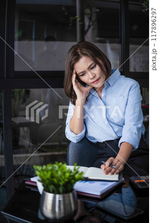 Businesswoman is thinking and is stressed about work. 117896297