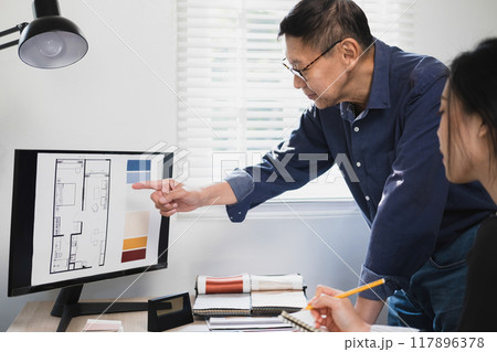 Businesswoman sitting at desk on couch in workplace  117896378