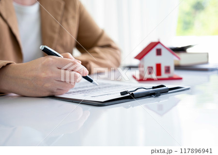 A woman viewing real estate contract 117896941