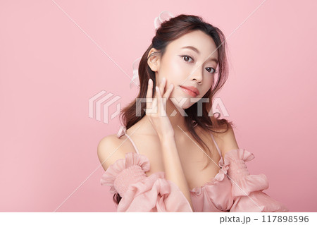 Beautiful young asian woman with clean fresh skin on pink background, Face care, Facial treatment, Cosmetology, beauty and spa, Asian women portrait. Beautiful young asian woman with clean fresh skin on pink background, Face care, Facial treatment, Cosmetology, beauty and spa, Asian women portrait. 117898596