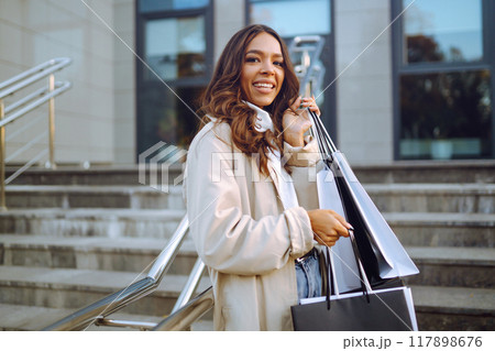 Young woman with shopping bags. Consumerism, purchases, shopping, lifestyle, sale concept. 117898676