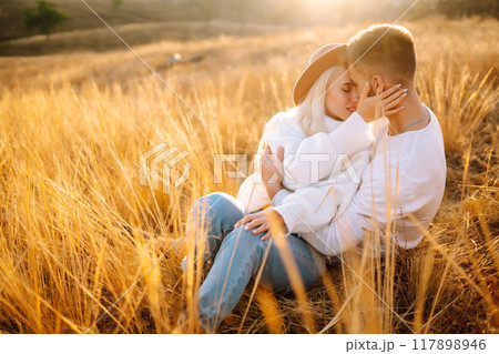 Young couple having fun walking and hugging n the park. Autumn weather. Relaxation, youth. Young couple having fun walking and hugging n the park. Autumn weather. Relaxation, youth. 117898946