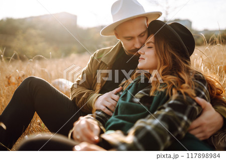 Lovely hipster couple enjoying each other in the autumn park. Nice autumn day. love and lifestyle. 117898984