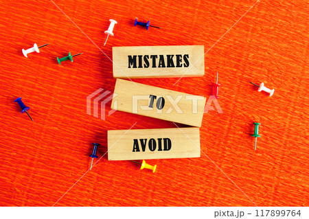 Conceptual mistakes to avoid symbol. Copy space. Mistakes to avoid message written composition from wooden blocks, top view. Conceptual text 117899764