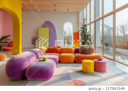 A modern, colorful living room with an arched window and large windows on the right side of the photo. 117901549
