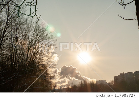 Smoke from a chimney against the background of a sunny sky. 117905727