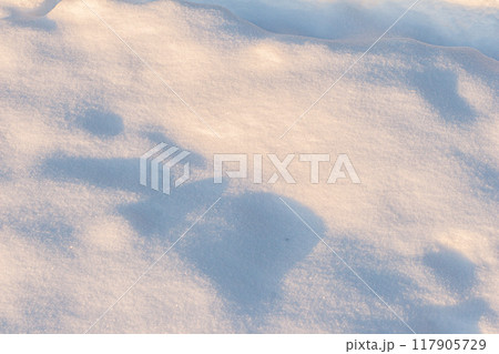 Uneven snow surface close-up. 117905729