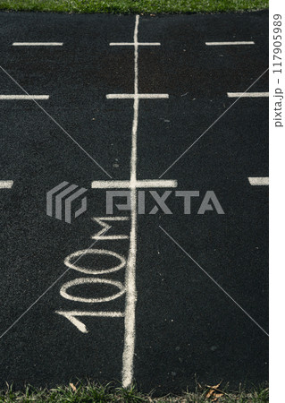 A rubber treadmill at the stadium. White markings on the stadium track 117905989