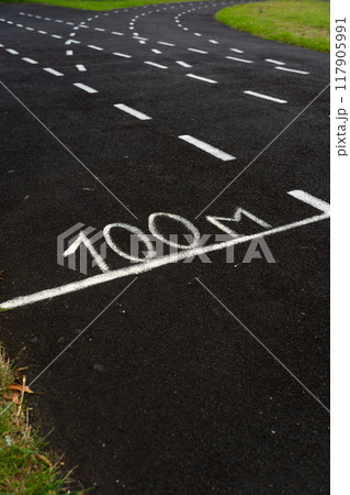 A rubber treadmill at the stadium. White markings on the stadium track 117905991