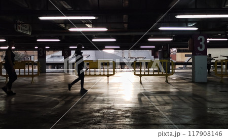 people walk through the closed parking. people walk through the closed parking. 117908146