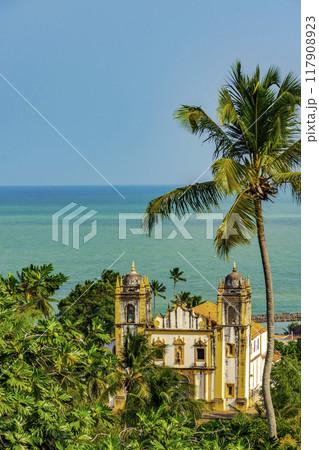 Church between vegetation and the sea 117908923
