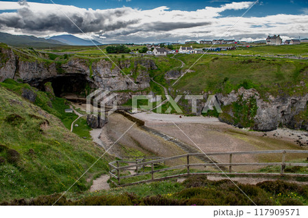 Entrance With Bridge To Smoo Cave, Hideout Of Bonnie Prince Charles, At The Atlantic Coast Of Village Durness In Scotland, UK Entrance With Bridge To Smoo Cave, Hideout Of Bonnie Prince Charles, At The Atlantic Coast Of Village Durness In Scotland, UK 117909571