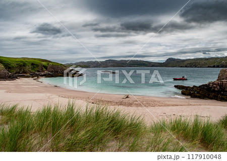 White Sand Beach On Seabird Protection Reserve Handa Island With Ferry Boat Near Village Tarbet In Scotland, UK White Sand Beach On Seabird Protection Reserve Handa Island With Ferry Boat Near Village Tarbet In Scotland, UK 117910048