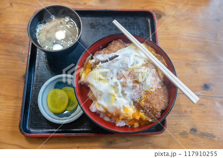 Katsudon breaded deep fried pork cutlet tonkatsu on top over rice 117910255